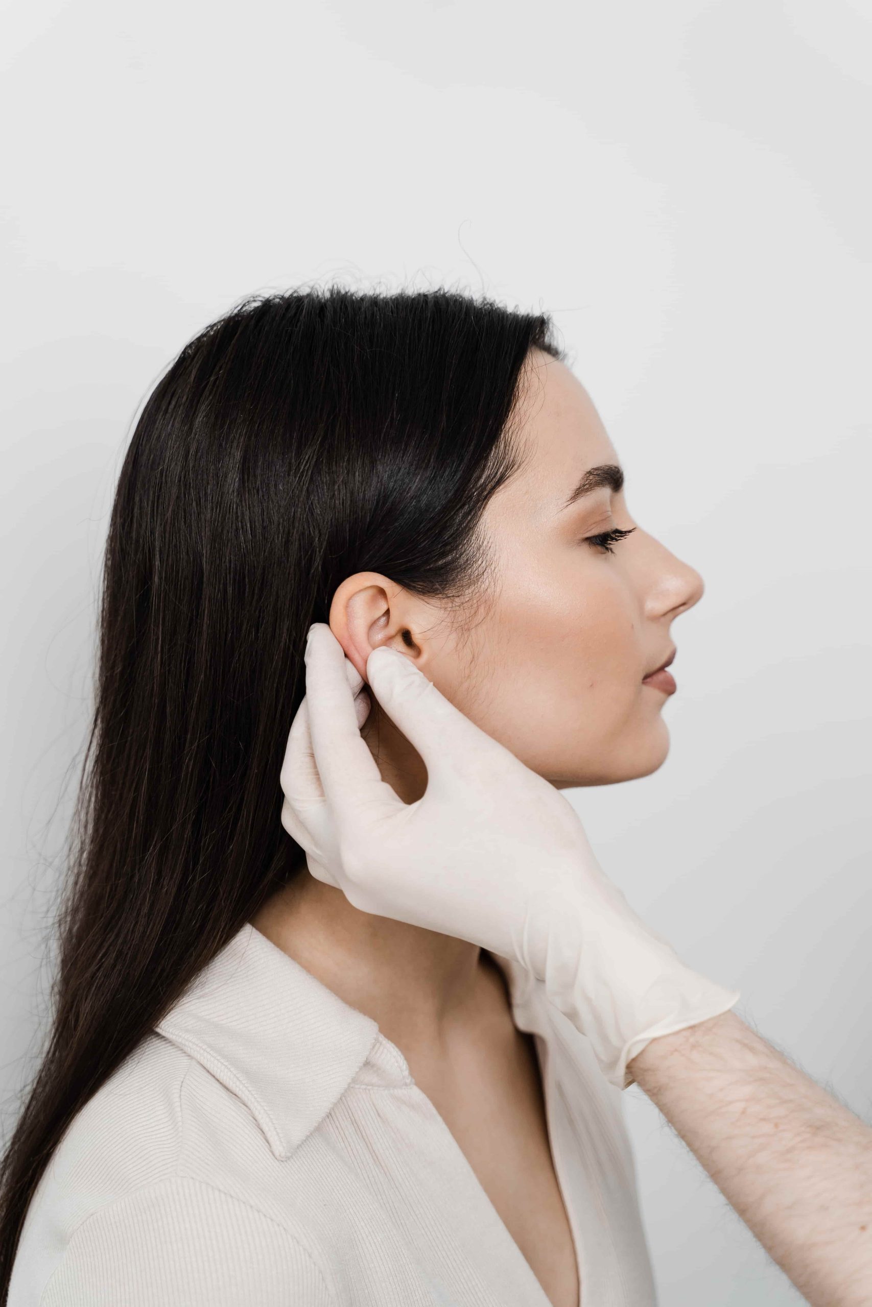 otoplasty ear surgery otoplasty surgical reshaping pinna ear surgeon doctor examines girl ears before otoplasty cosmetic surgery 1 scaled