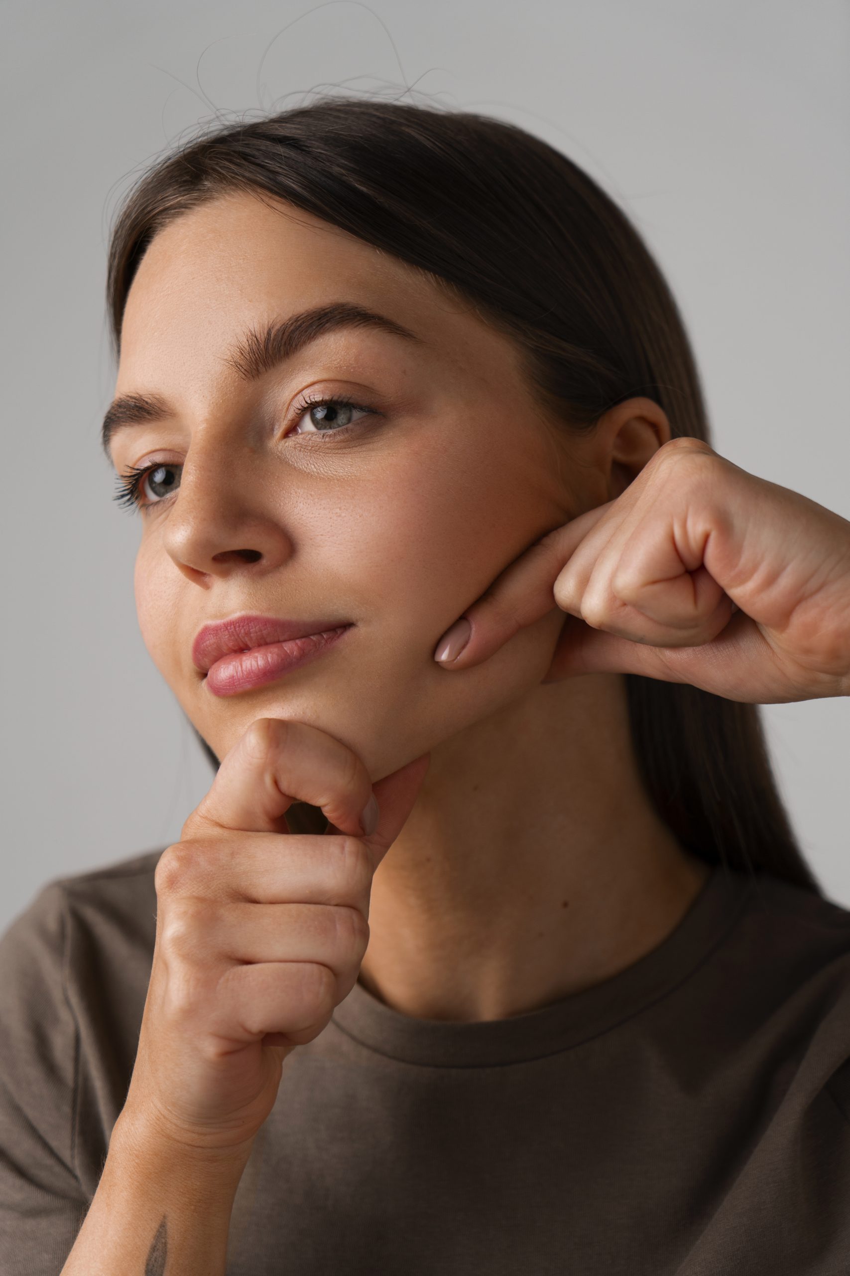 side view woman practicing facial yoga scaled
